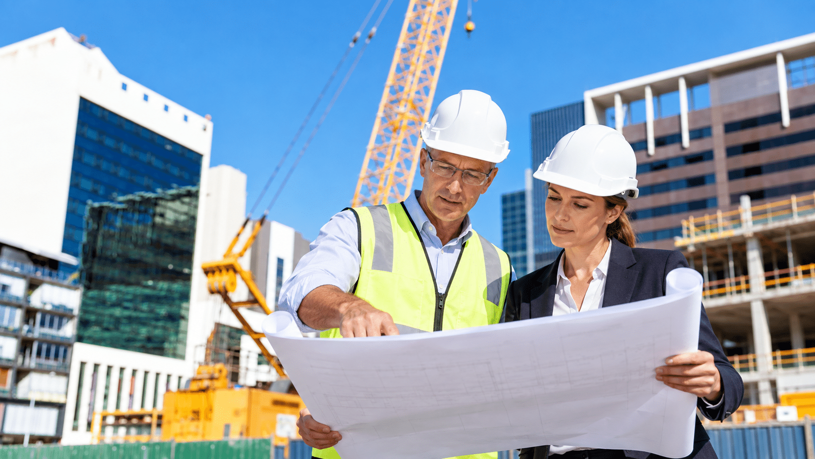 Commercial builder reviewing design plans with consultant on a Design and Construct project